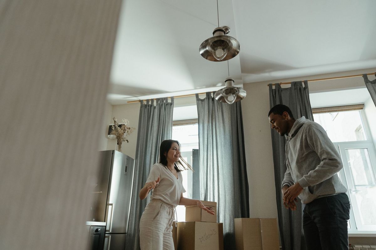 A couple unpacking moving boxes in their new home