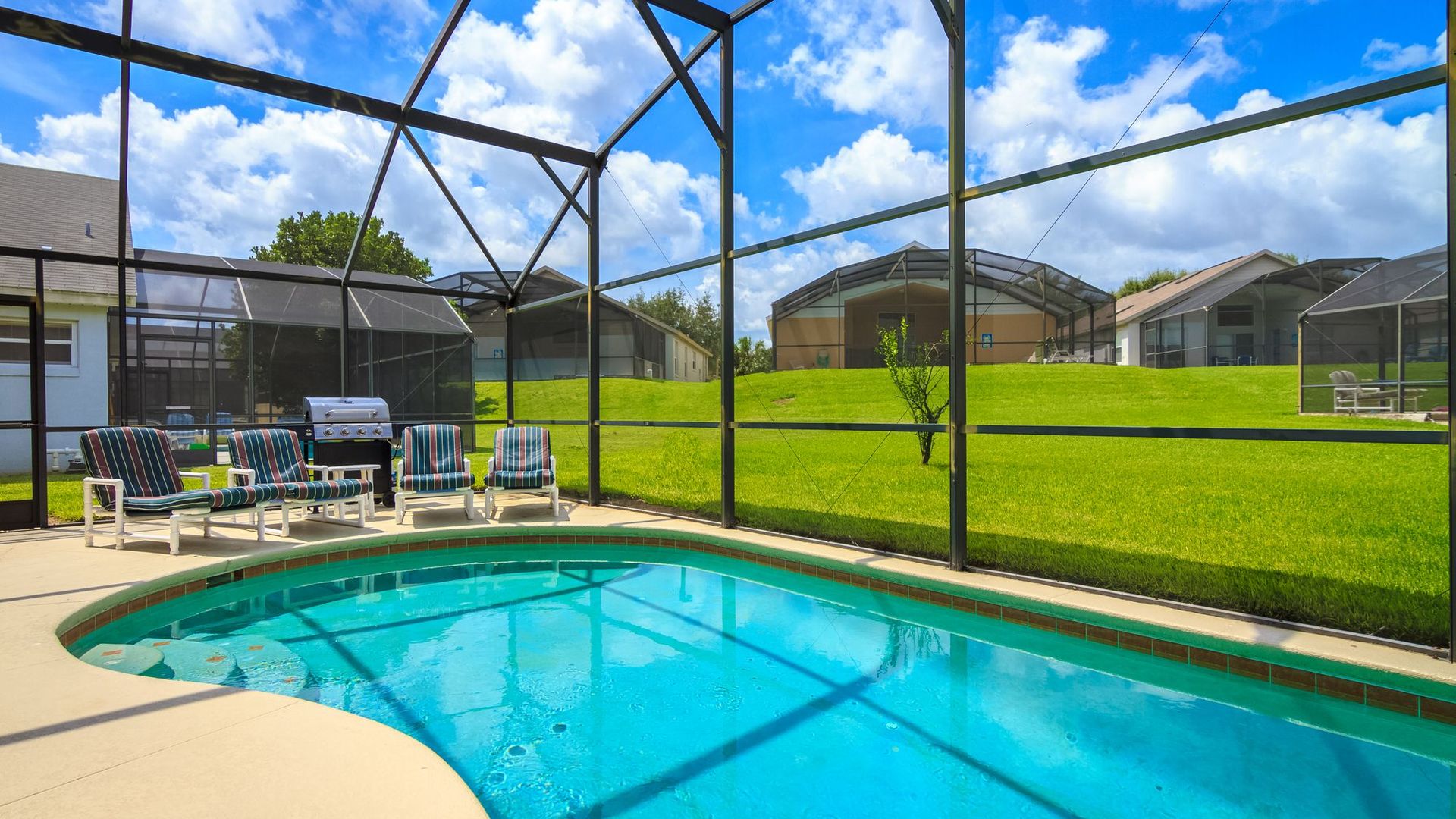 A screened-in pool and patio behind a Florida home