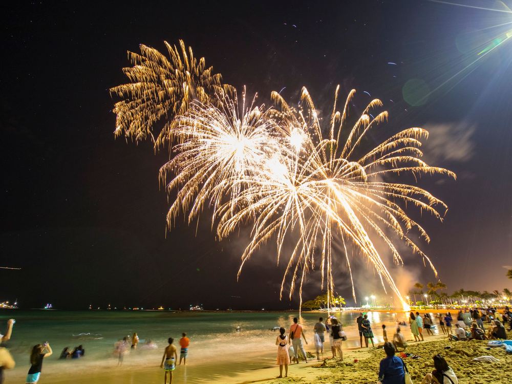 Fireworks over the water at night