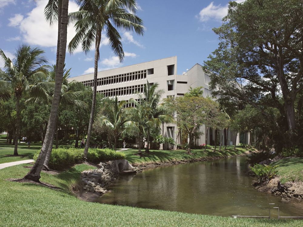 University campus with a canal and palm trees in South Florida