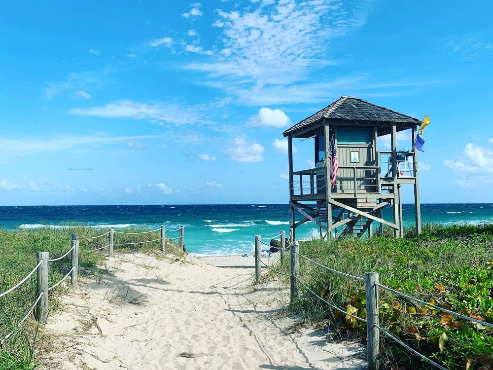 Lifeguard tower and a sand path to the beach in Deerfield Beach