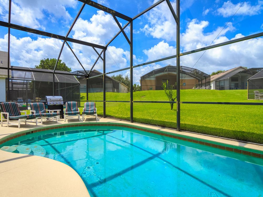 Screened pool enclosure behind a Florida home
