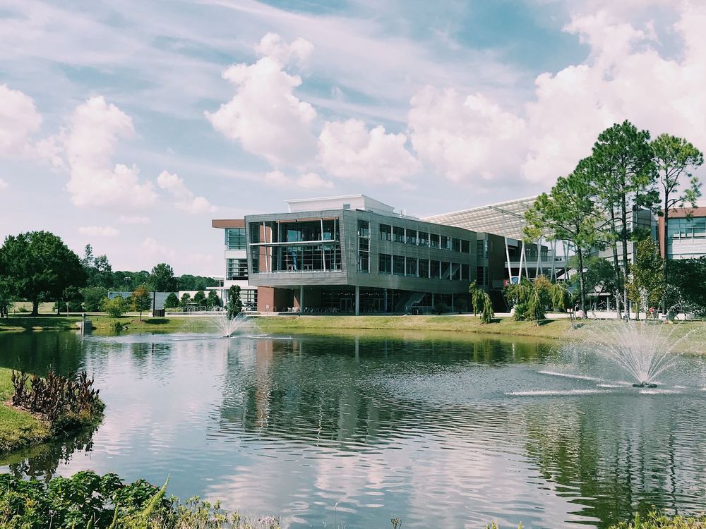 Modern campus building by a pond with a fountain in Florida